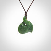 Hand carved New Zealand jade, single twist pendant. Maori pikorua pendant hand carved in New Zealand. Made by NZ Pacific, jade jewellery for sale online. One only hand made by Ross Crump.